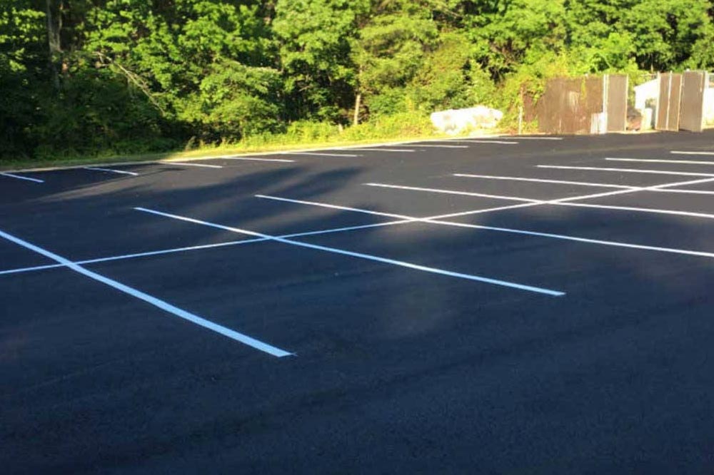 Team finishing the edges of a new asphalt path